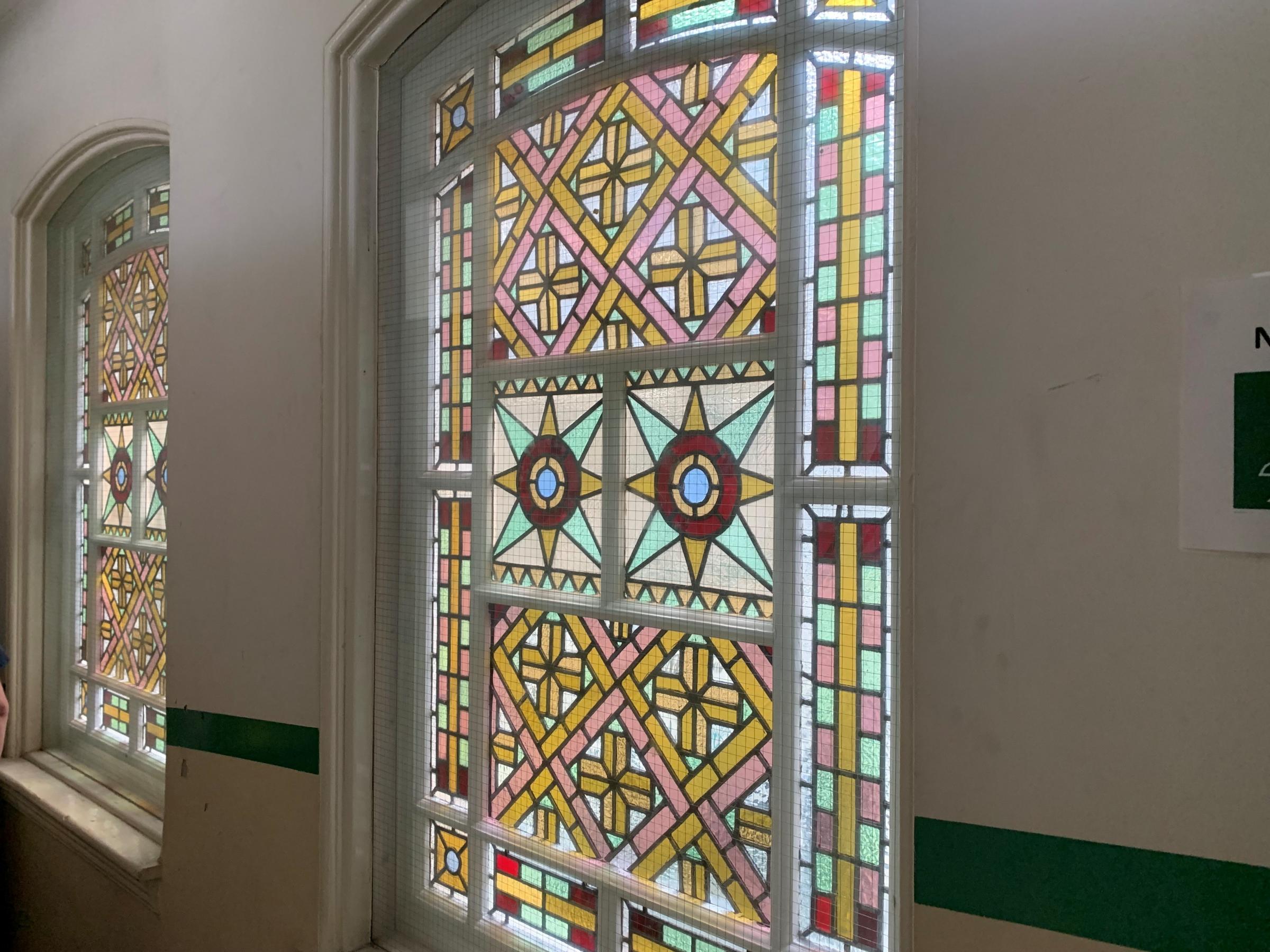 A stained glass window in an upstairs Health Hydro room